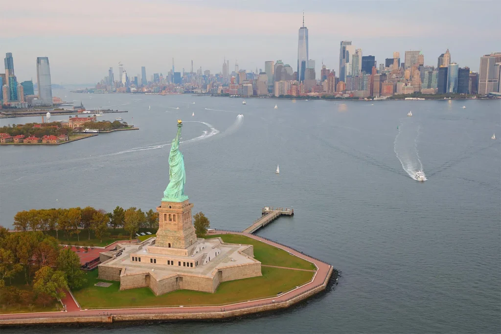 View of the Statue of Liberty with a sleepy New York in the background.